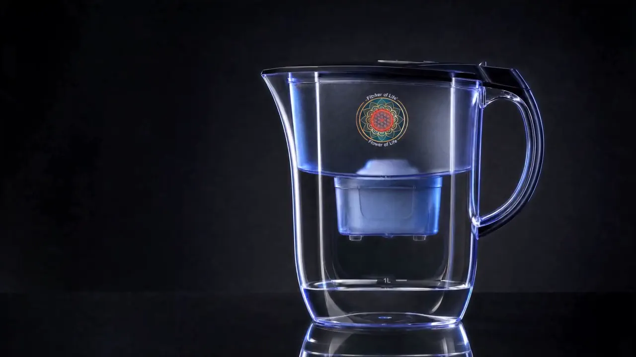 Pitcher of Life with its Flower of Life emblem and filter cartridge, on a dark surface